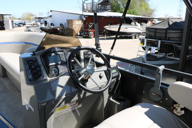 Slide: The Image of Interior view of 2023 Qwest E820 XRE CR L boat with steering wheel and control panel. - 27