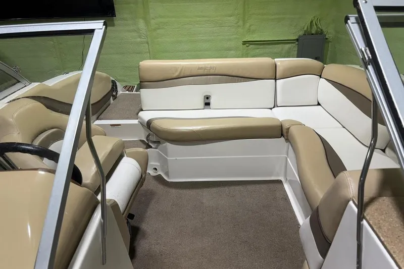Slide: The Image of 2014 Starcraft Crossover 230 SCX IO boat interior with beige and white seating. - 15