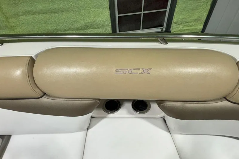 Slide: The Image of 2014 Starcraft Crossover 230 SCX IO boat interior with beige seating and SCX logo. - 16