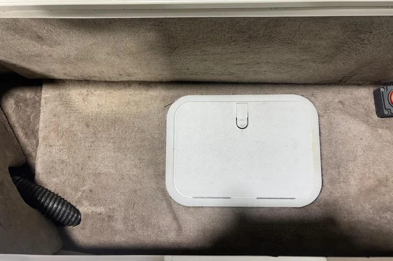 Slide: The Image of Interior compartment of 2014 Starcraft Crossover 230 SCX IO boat, featuring a storage hatch. - 20