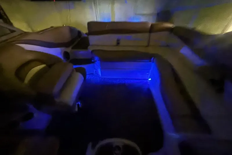 Slide: The Image of 2014 Starcraft Crossover 230 SCX IO boat interior with blue ambient lighting. - 27