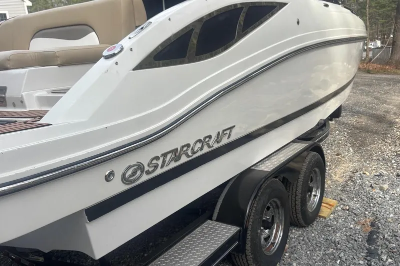 Slide: The Image of 2014 Starcraft Crossover 230 SCX IO boat on a trailer, side view. - 3