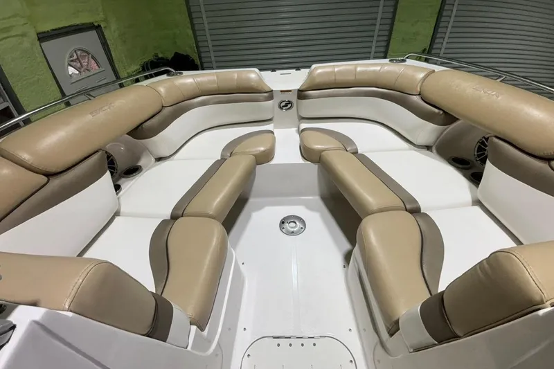 Slide: The Image of 2014 Starcraft Crossover 230 SCX IO boat interior with beige seating and white accents. - 8