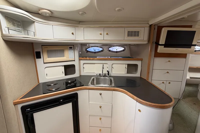 Slide: The Image of Interior of a 1996 Maxum 3700 SCR yacht kitchen with modern amenities. - 10