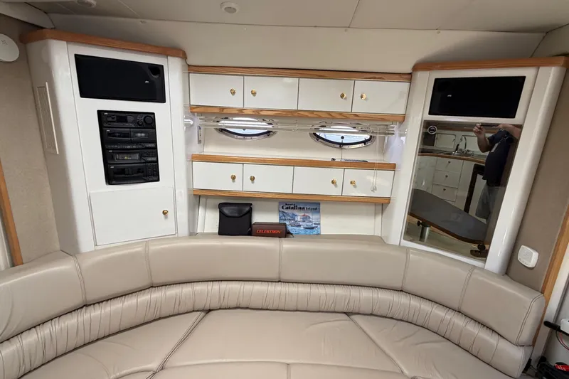 Slide: The Image of Interior of 1996 Maxum 3700 SCR yacht with beige seating and wooden cabinetry. - 12
