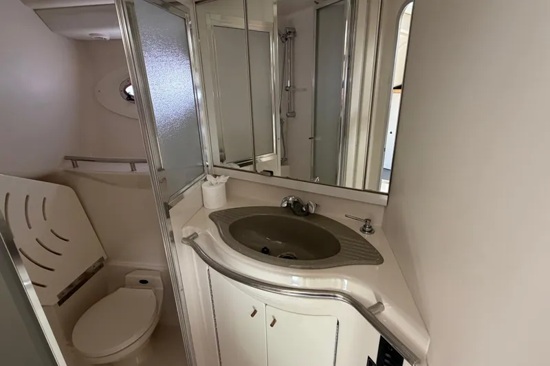 Slide: The Image of Bathroom interior of 1996 Maxum 3700 SCR yacht with sink, toilet, and shower. - 14