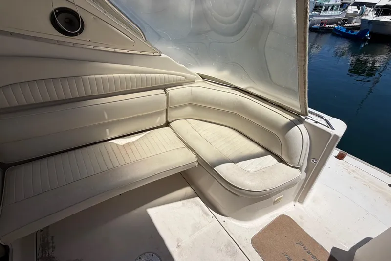 Slide: The Image of Interior seating of a 1996 Maxum 3700 SCR boat, docked at a marina. - 15