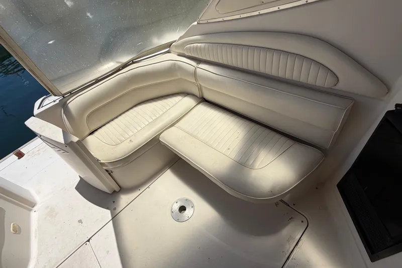 Slide: The Image of 1996 Maxum 3700 SCR boat interior with white cushioned seating area. - 16