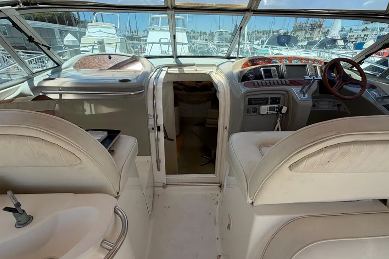 Slide: The Image of Interior view of a 1996 Maxum 3700 SCR yacht cockpit with steering wheel and controls. - 18