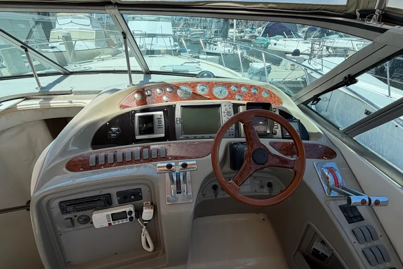 Slide: The Image of 1996 Maxum 3700 SCR boat cockpit with steering wheel and control panel. - 19