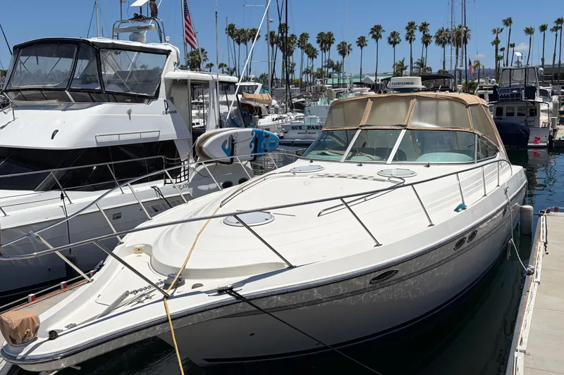 Slide: The Image of 1996 Maxum 3700 SCR yacht docked in a marina, surrounded by other boats. - 4