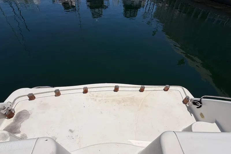 Slide: The Image of 1996 Maxum 3700 SCR boat deck overlooking calm marina waters. - 7