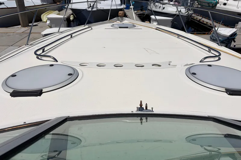 Slide: The Image of 1996 Maxum 3700 SCR yacht deck with circular hatches, docked at marina. - 8