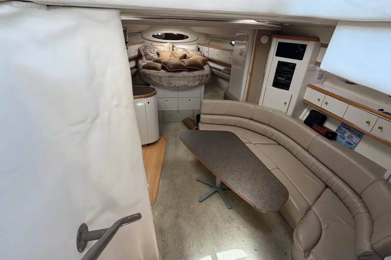 Slide: The Image of Interior of 1996 Maxum 3700 SCR yacht with beige seating and table. - 9