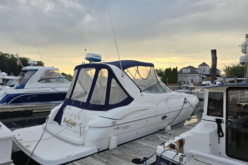 Slide: The Image of 2004 Cruisers 320 Express yacht docked at marina during sunset. - 3