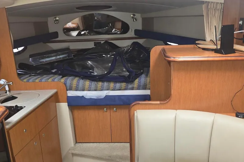 Slide: The Image of Interior of 2004 Cruisers 320 Express yacht with cozy cabin and kitchenette. - 9