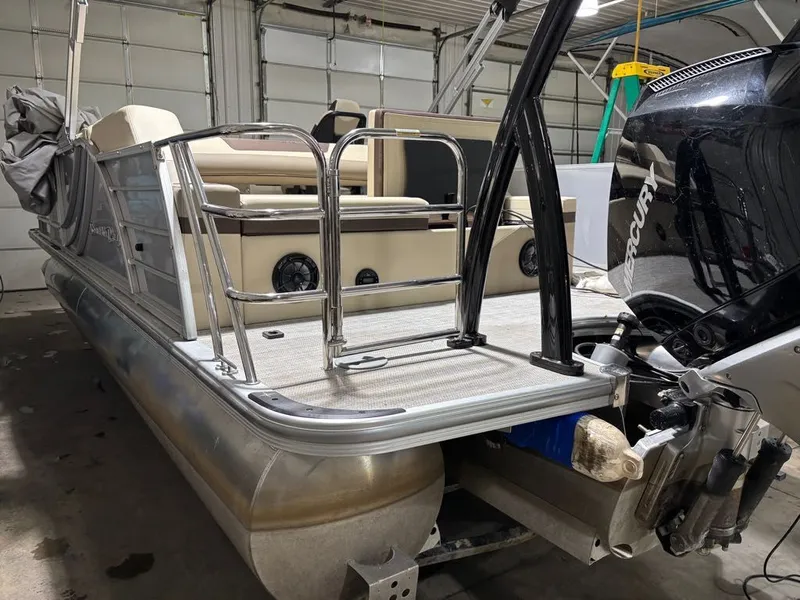 Slide: The Image of 2023 South Bay 500 Series pontoon boat in garage. - 14
