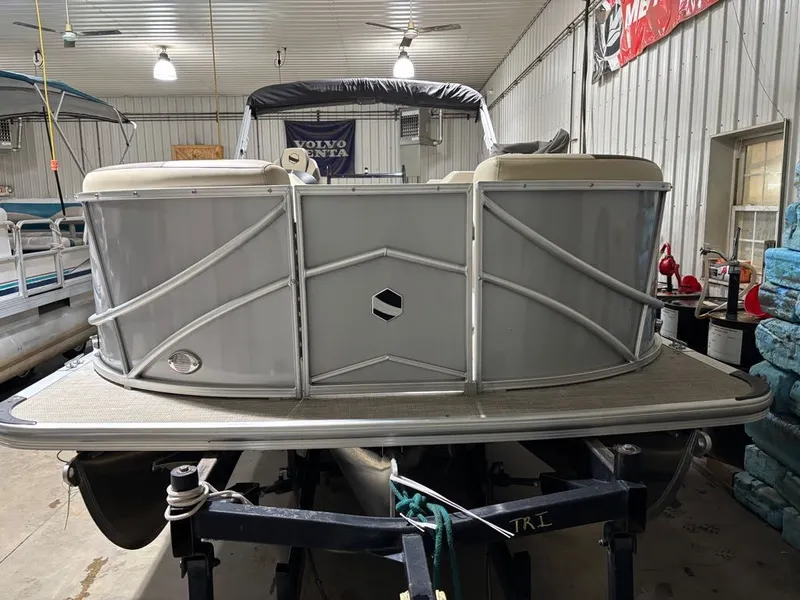 Slide: The Image of 2023 South Bay 500 Series pontoon boat in storage facility. - 4