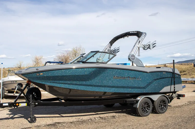 Slide: The Image of 2026 MasterCraft NXT22 boat on trailer, blue glittering design. - 4