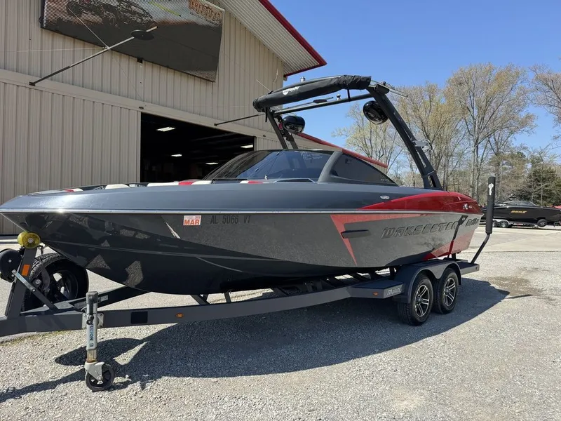 Slide: The Image of 2015 Malibu Wakesetter 22 VLX boat on trailer outside warehouse. - 3