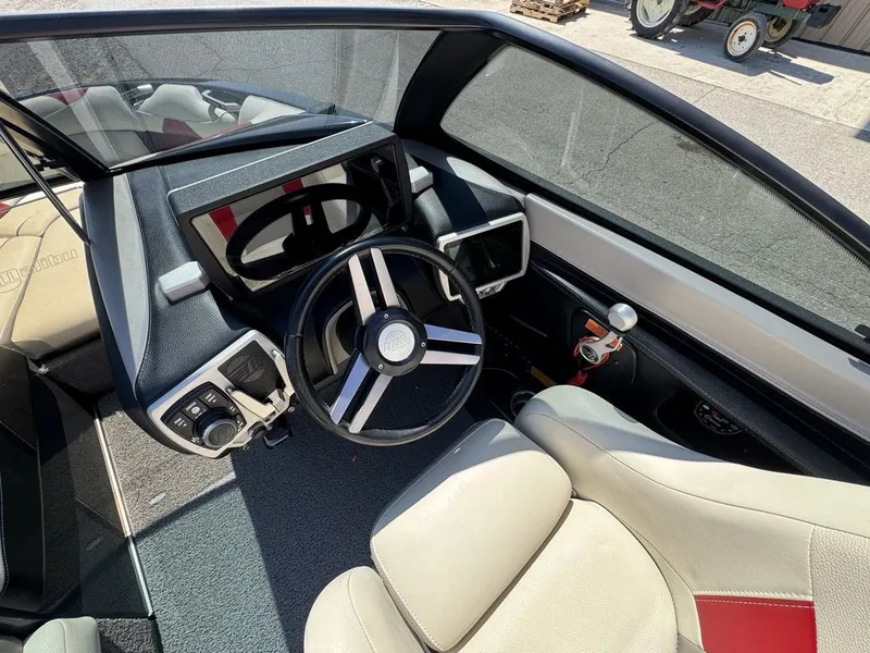Slide: The Image of Interior of a 2015 Malibu Wakesetter 22 VLX boat with steering wheel and controls. - 7