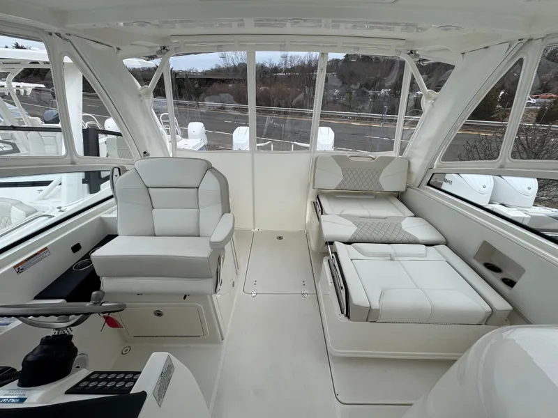 Slide: The Image of Interior of 2026 World Cat 325DC featuring luxurious white seating. - 16