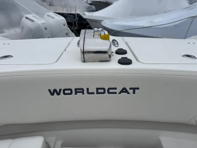 Slide: The Image of World Cat 325DC boat 2026, close-up of logo on white seat. - 7