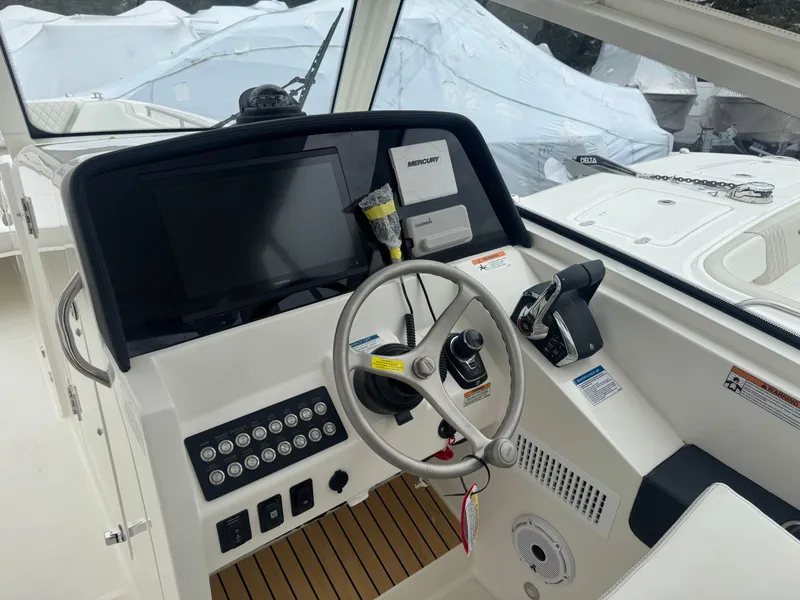 Slide: The Image of 2026 World Cat 325DC helm with modern electronics and controls. - 8