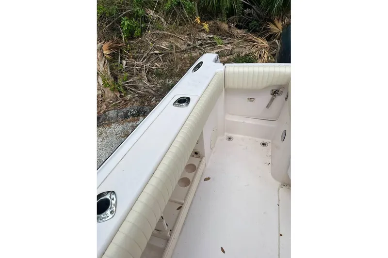 Slide: The Image of 2007 Grady-White Bimini 306 boat interior with rod holders and cushioned seating. - 5