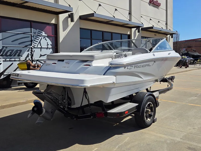 Slide: The Image of 2019 Regal 1900 ES Bowrider on trailer outside a building. - 8