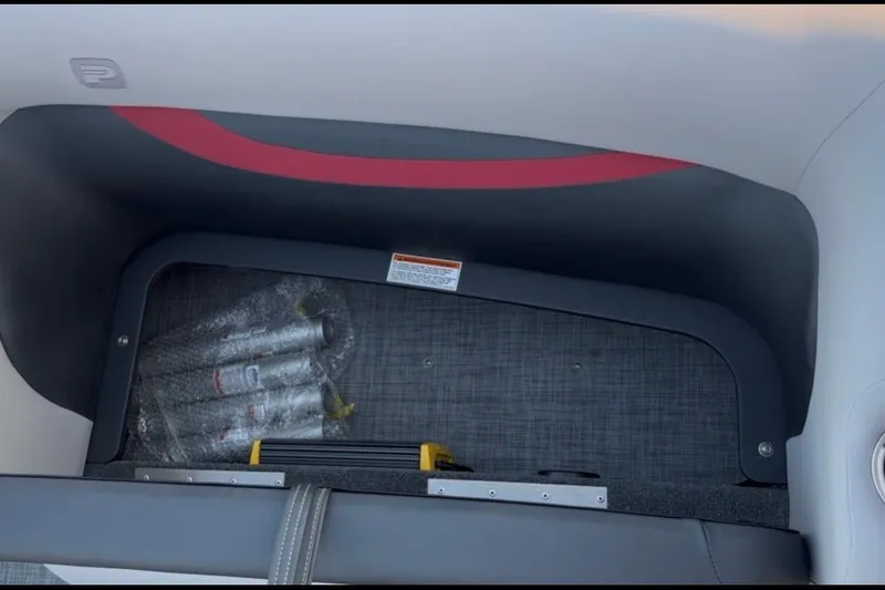 Slide: The Image of Interior storage compartment of 2026 Princecraft Ventura 224 boat with safety equipment. - 14
