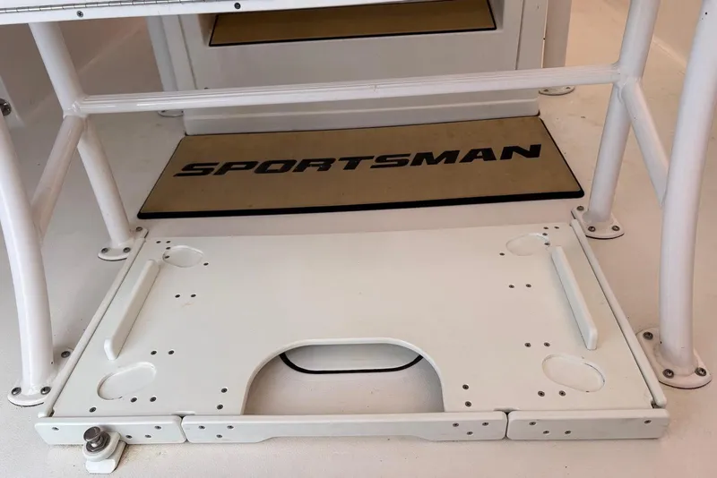 Slide: The Image of 2023 Sportsman Open 232 Center Console boat deck with branded mat and sturdy framework. - 10