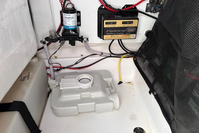 Slide: The Image of 2023 Sportsman Open 232 Center Console wiring and pump system in boat compartment. - 12