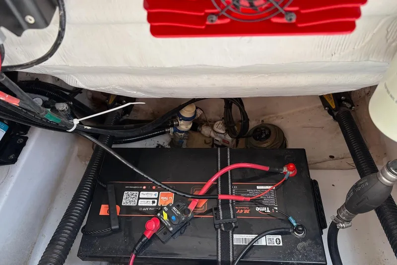 Slide: The Image of Battery compartment of 2023 Sportsman Open 232 Center Console boat, showing wiring and components. - 15