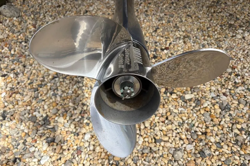 Slide: The Image of Close-up of a shiny boat propeller on gravel, 2023 Sportsman Open 232 Center Console. - 17