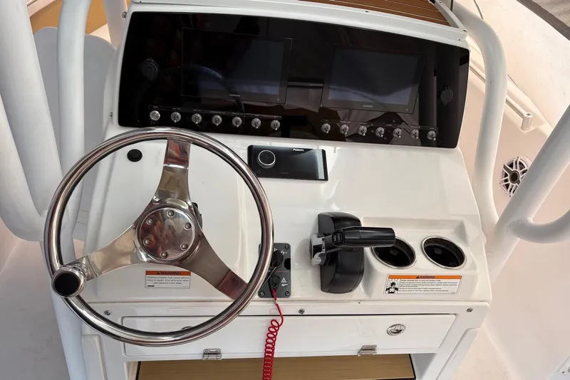 Slide: The Image of 2023 Sportsman Open 232 Center Console dashboard with steering wheel and controls. - 4