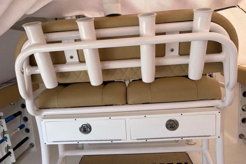 Slide: The Image of 2023 Sportsman Open 232 Center Console boat seat with rod holders and storage drawers. - 6