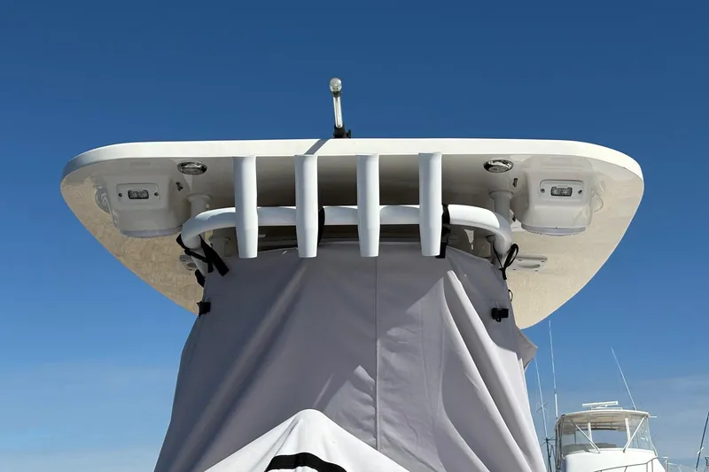 Slide: The Image of 2023 Sportsman Open 232 Center Console boat with T-top against clear blue sky. - 7