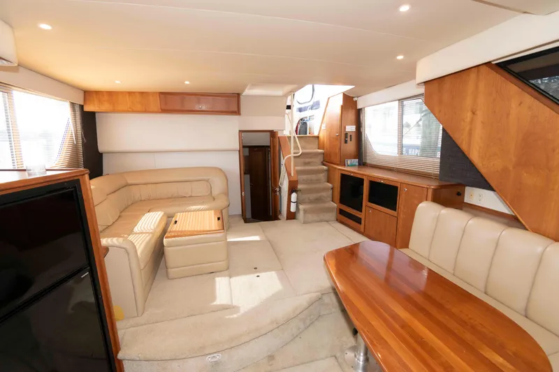 Slide: The Image of Luxurious interior of 2001 Silverton 392 Motor Yacht with plush seating and wooden accents. - 10