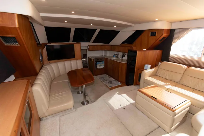 Slide: The Image of Luxurious interior of a 2001 Silverton 392 Motor Yacht with elegant seating and kitchenette. - 11