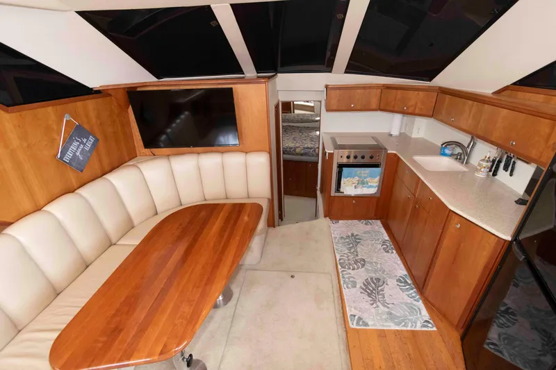 Slide: The Image of Interior of 2001 Silverton 392 Motor Yacht with kitchen and dining area. - 13