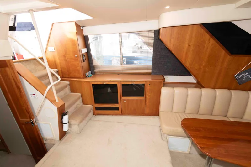 Slide: The Image of Interior of 2001 Silverton 392 Motor Yacht with wood cabinetry and beige seating. - 14