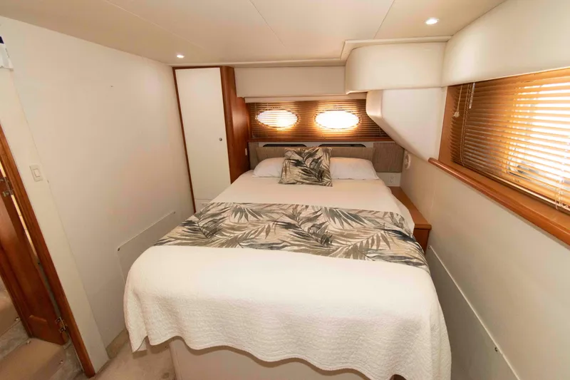 Slide: The Image of Luxurious bedroom interior of 2001 Silverton 392 Motor Yacht with cozy bedding. - 17