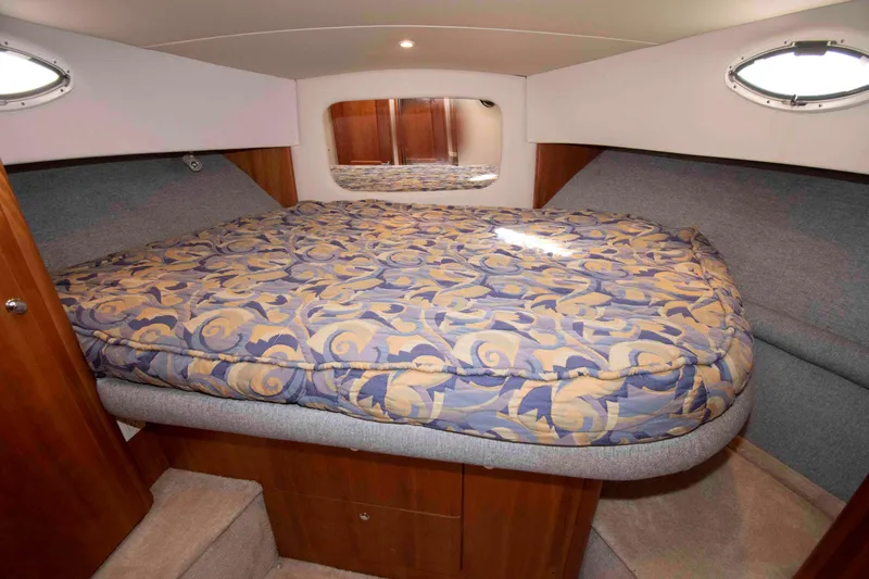 Slide: The Image of Luxurious bedroom interior of 2001 Silverton 392 Motor Yacht with patterned bedding. - 19