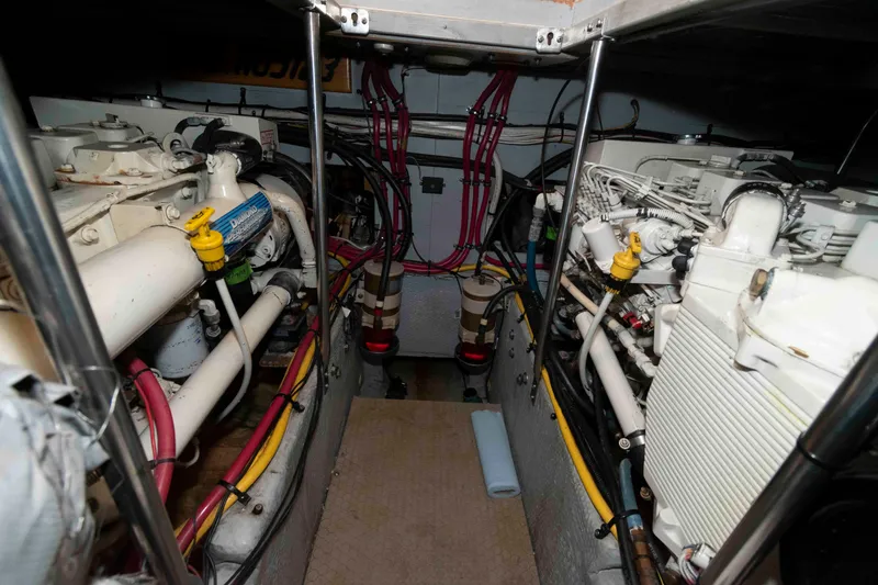Slide: The Image of Engine room of a 2001 Silverton 392 Motor Yacht, showcasing dual engines and wiring. - 21