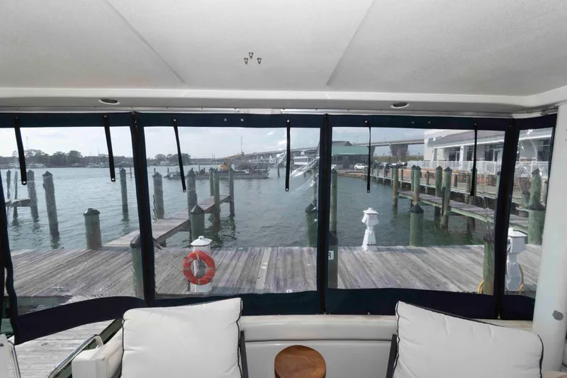Slide: The Image of Interior view from a 2001 Silverton 392 Motor Yacht overlooking a marina dock. - 3