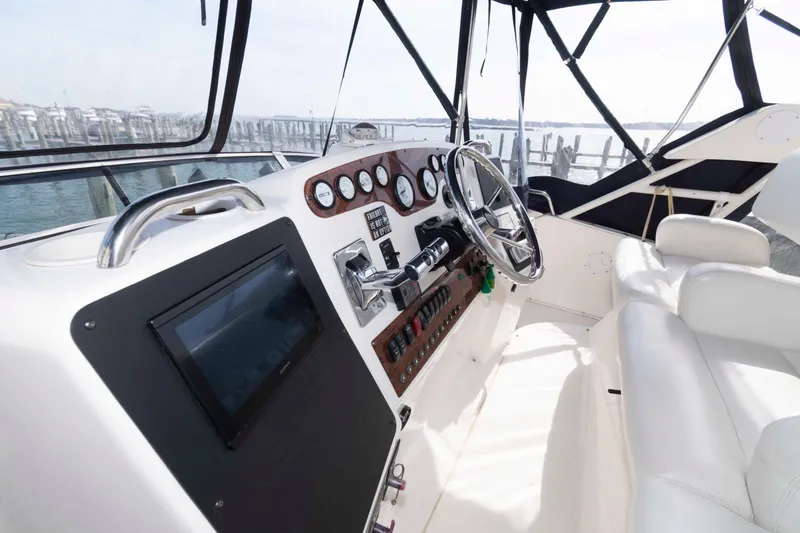 Slide: The Image of 2001 Silverton 392 Motor Yacht helm with steering wheel and control panel. - 4