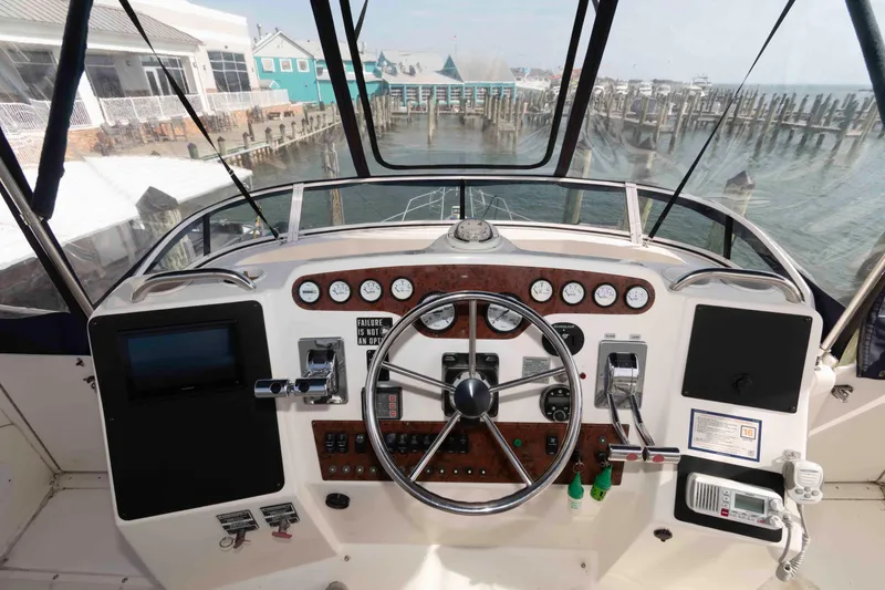 Slide: The Image of Cockpit view of 2001 Silverton 392 Motor Yacht with steering wheel and control panel. - 8