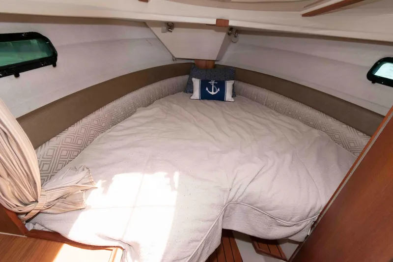 Slide: The Image of Cozy cabin interior of 2020 Ranger Tugs R-27 with nautical-themed decor. - 12