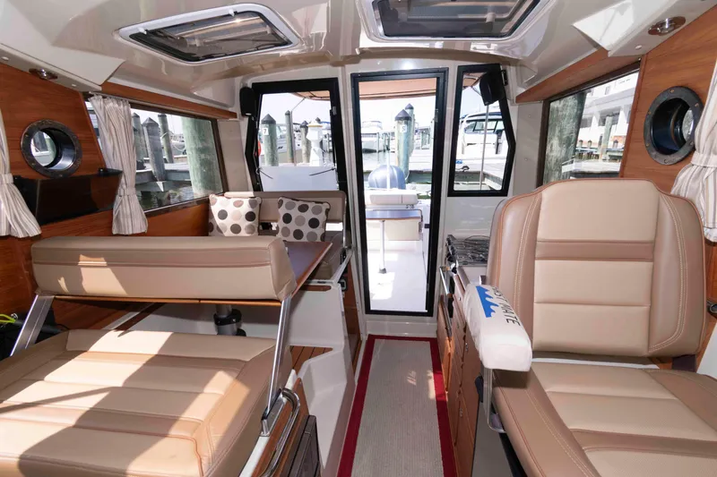 Slide: The Image of Interior of 2020 Ranger Tugs R-27 boat with seating and windows. - 14